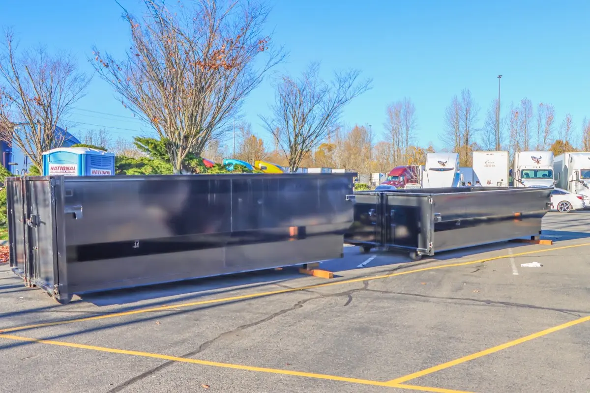 Professional dumpster rental service with roll-off container on residential driveway in Parole